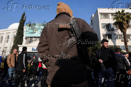 Former members of Syria's Bashar Al Assad's security forces wait to register for the identification and reconciliation process, in Damascus