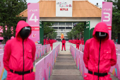 People dressed as guards from the Netflix series Squid Game attend an event at the Gelora Bung Karno Stadium ahead of the release of the Netflix series Squid Game: Season 2 in Jakarta