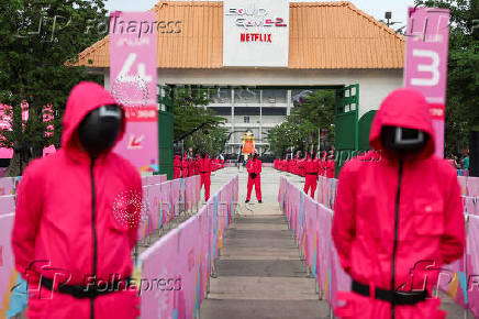 People dressed as guards from the Netflix series Squid Game attend an event at the Gelora Bung Karno Stadium ahead of the release of the Netflix series Squid Game: Season 2 in Jakarta