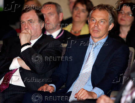 FILE PHOTO: Former Labour Party Deputy Leader Prescott and Prime Minister Blair listen to incoming Prime Minister Brown's speech during the Labour Leadership Conference in northern England