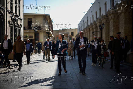 Britain's Home Secretary Yvette Cooper and UK ambassador to Iraq Stephen Hitchen visit Al-Mutanabbi Street, in Baghdad