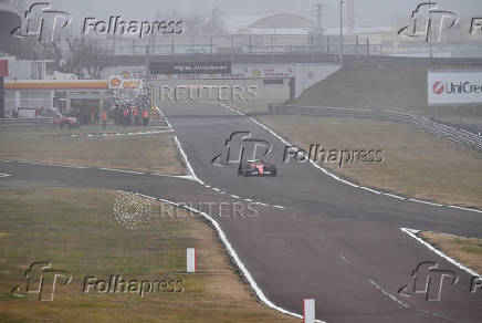 Lewis Hamilton drives a Ferrari F1 car around the Fiorano circuit as part of the TPC tests