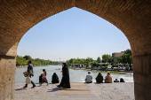 Iranians rest near the Zayandeh Rud River, after a reported Israeli attack on Iran, in Isfahan Province