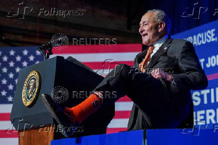 U.S. Senate Majority LeaderChuckSchumer(D-NY) shows off his Syracuse University orange socks, in Syracuse