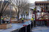 Construction workers finish up the inagural reviewing stand