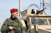 FILE PHOTO: Member of Kurdish-led Syrian Democratic Forces (SDF) stands along a street in Hasakah