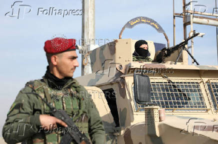 FILE PHOTO: Member of Kurdish-led Syrian Democratic Forces (SDF) stands along a street in Hasakah