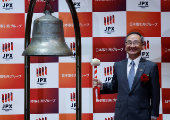 Akiyoshi Yamamura, President of Tokyo Metro smiles after ringing a bell at a ceremony to mark the company's debut on the Tokyo Stock Exchange in Tokyo