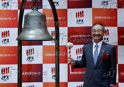 Akiyoshi Yamamura, President of Tokyo Metro smiles after ringing a bell at a ceremony to mark the company's debut on the Tokyo Stock Exchange in Tokyo