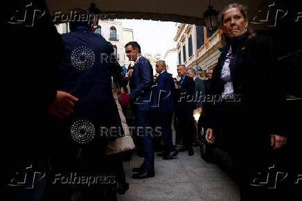 Spanish PM Sanchez talks to the media after attending a vote on a fiscal package extending a windfall tax on banks at Parliament in Madrid