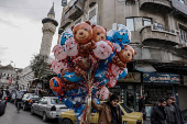 Man sells balloons, after Syria's Bashar al-Assad was ousted, at the downtown of Damascus