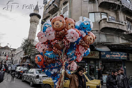 Man sells balloons, after Syria's Bashar al-Assad was ousted, at the downtown of Damascus