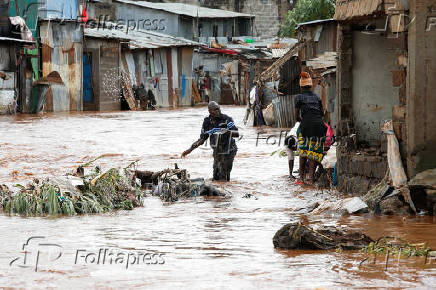 Residents recover their belongings after the Nairobi river burst its banks in Mathare Valley settlement in Nairobi