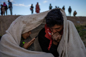 Migrants awake in cold weather along international border between Mexico and United States
