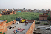 A woman puts her clothes to dry on a terrace in a neighbourhood in Loni town in the northern state of Uttar Pradesh