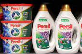 Persil products are displayed on a shelf in a supermarket