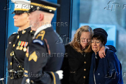 Mourners view the casket of former U.S. President Jimmy Carter as he lies in repose at the Jimmy Carter Presidential Library and Museum