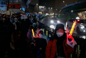 Pro-Yoon protesters are seen in the early light after rallying throughout the night in support of impeached South Korean President Yoon Suk Yeol near his official residence, in Seoul