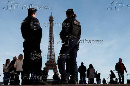 FILE PHOTO: French police patrol near the Eiffel Tower in Paris