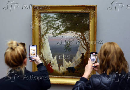 People view painting 'Chalk Cliffs of Ruegen' by German Romantic landscape painter Caspar David Friedrich in Berlin