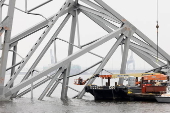 Authorities work to clean up the wreckage of the Francis Scott Key Bridge and reopen the Port of Baltimore