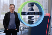 Bill Anderson, CEO of Germany's drug maker Bayer AG poses for a portrait session next to the company?s logo at the Bayer headquarters in Leverkusen