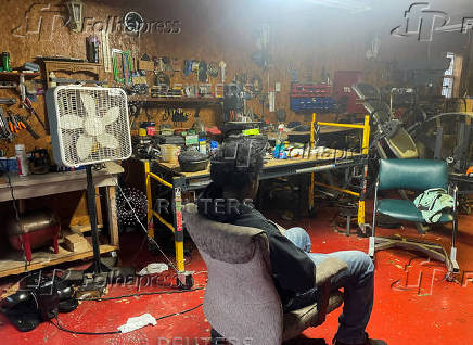 Abdur Rahim Jabbar, half-brother of the Texas truck attack accused, sits in the garage of their house in Beaumont