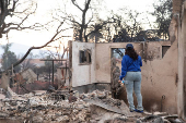 Desiree Johnson views her home that was destroyed by the Eaton Fire in Altadena