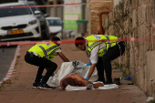 Israeli security forces secure the area where a suspected stabbing incident took place, in Ramle