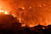 Wildfire burns next to the village of Ano Loutro, near Corinth