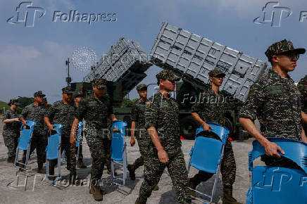 Members of the Taiwanese navy Hai Feng (Sea Blade) Group walk in front of Hsiung Feng III and II mobile missile launchers after Taiwanese President Lai Ching-te?s visit to the base in response to recent Chinese military drills, in Taoyuan