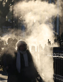 Commuters walk during the rush hour on a cold morning ahead of Ireland's general election, in Dublin