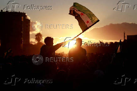 FILE PHOTO: People celebrate after fighters of the ruling Syrian body ousted Bashar al-Assad, in Damascus