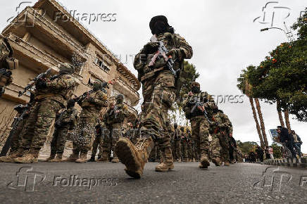 Khaled Brigade, a part of Hay'at Tahrir al-Sham (HTS), hold a military parade, in Damascus