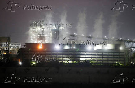 FILE PHOTO: Smoke billows from the cooling towers of a coal-fired power plant in Ahmedabad