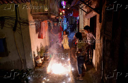 FILE PHOTO: People watch firecrackers burn during Diwali, the Hindu festival of lights, in Mumbai