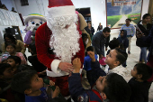 Migrants participate in a Posada ahead of Christmas, in Tijuana