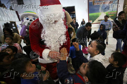 Migrants participate in a Posada ahead of Christmas, in Tijuana