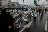 People take part in a protest against the impeached South Korean President Yoon Suk Yeol near his official residence on a snowy day in Seoul