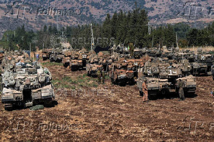 Israeli armoured military vehicles in formation, amid cross-border hostilities betweenHezbollahand Israel, in northern Israel