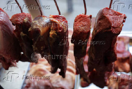 Pieces of meat hang at a butcher shop in Rio de Janeiro