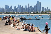 People relax on Melbourne St Kilda beach