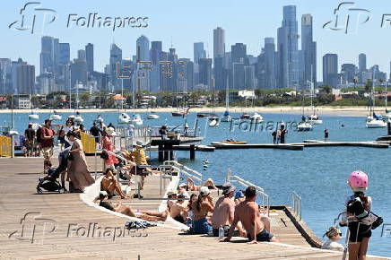 People relax on Melbourne St Kilda beach