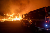 Firefighters and aircraft battle the Hughes Fire near Santa Clarita