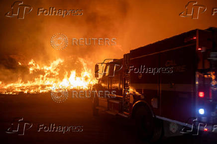 Firefighters and aircraft battle the Hughes Fire near Santa Clarita