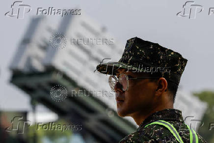 A soldier is seen in front of a Hsiung Feng III mobile missile launcher during Taiwanese President Lai Ching-te?s visit to the base in response to recent Chinese military drills, in Taoyuan