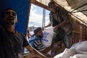 UNRWA agency hands out bags of flour to Palestinians in Khan Younis