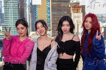 Members of the group Itzy pose in front of the Manhattan skyline during an interview with Reuters in New York