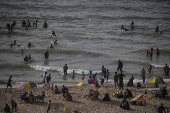 Internally displaced Palestinians spend their time at the beach west of Deir Al Balah town, southern Gaza Strip