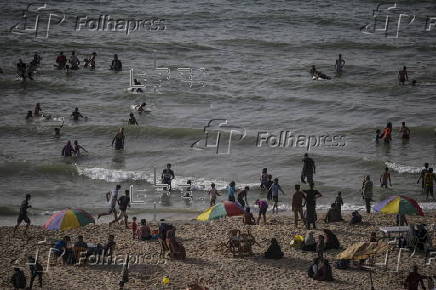 Internally displaced Palestinians spend their time at the beach west of Deir Al Balah town, southern Gaza Strip